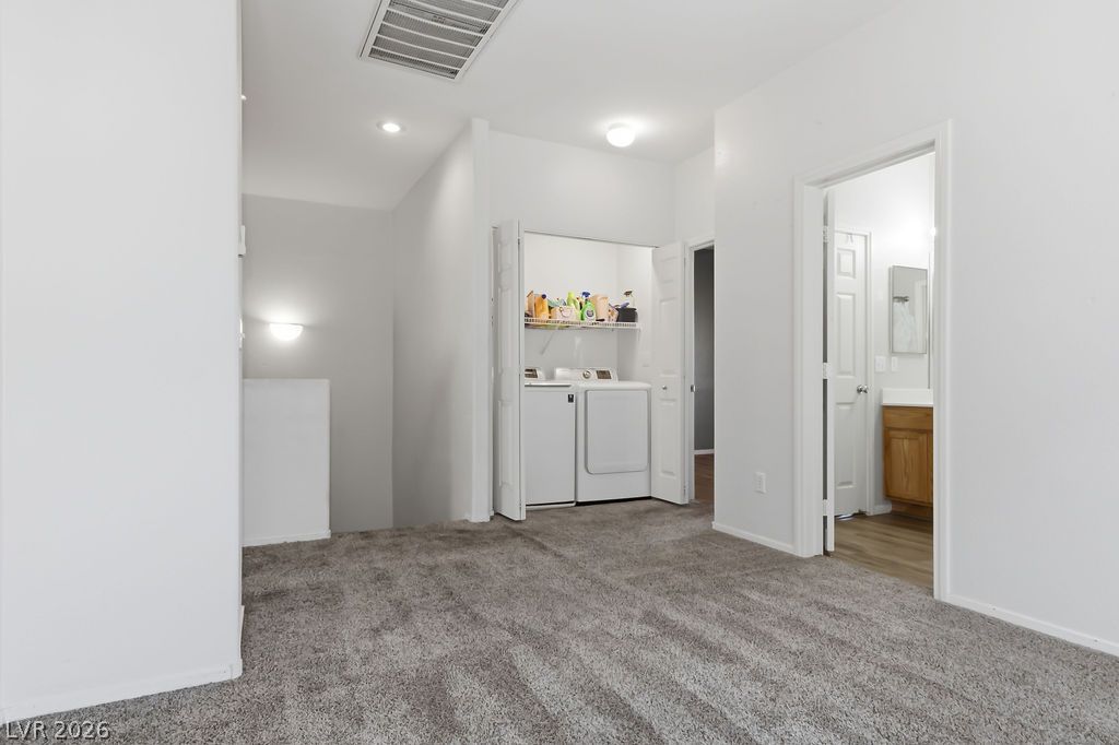 754 Solitude Point Avenue Henderson, NV 89012 - Photo 23 of 38 Conveniently located laundry space and accessible half bath complete this upper level.