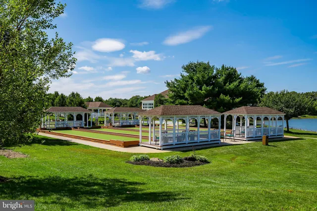 an aerial view of a house with a garden and lake view