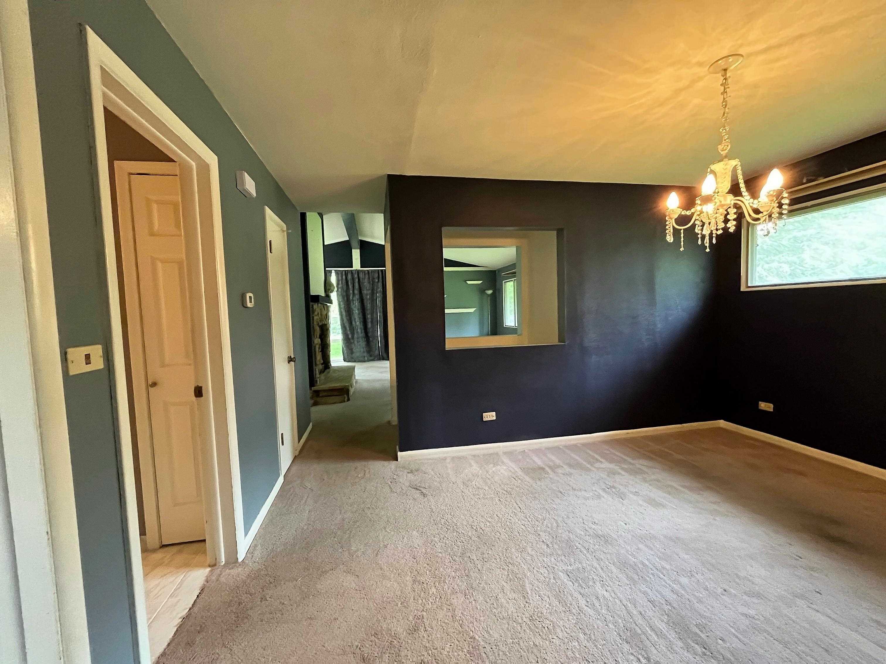 3405 North View Road Rockford, IL 61107 - Photo 7 of 33 a bedroom with a bed and a chandelier