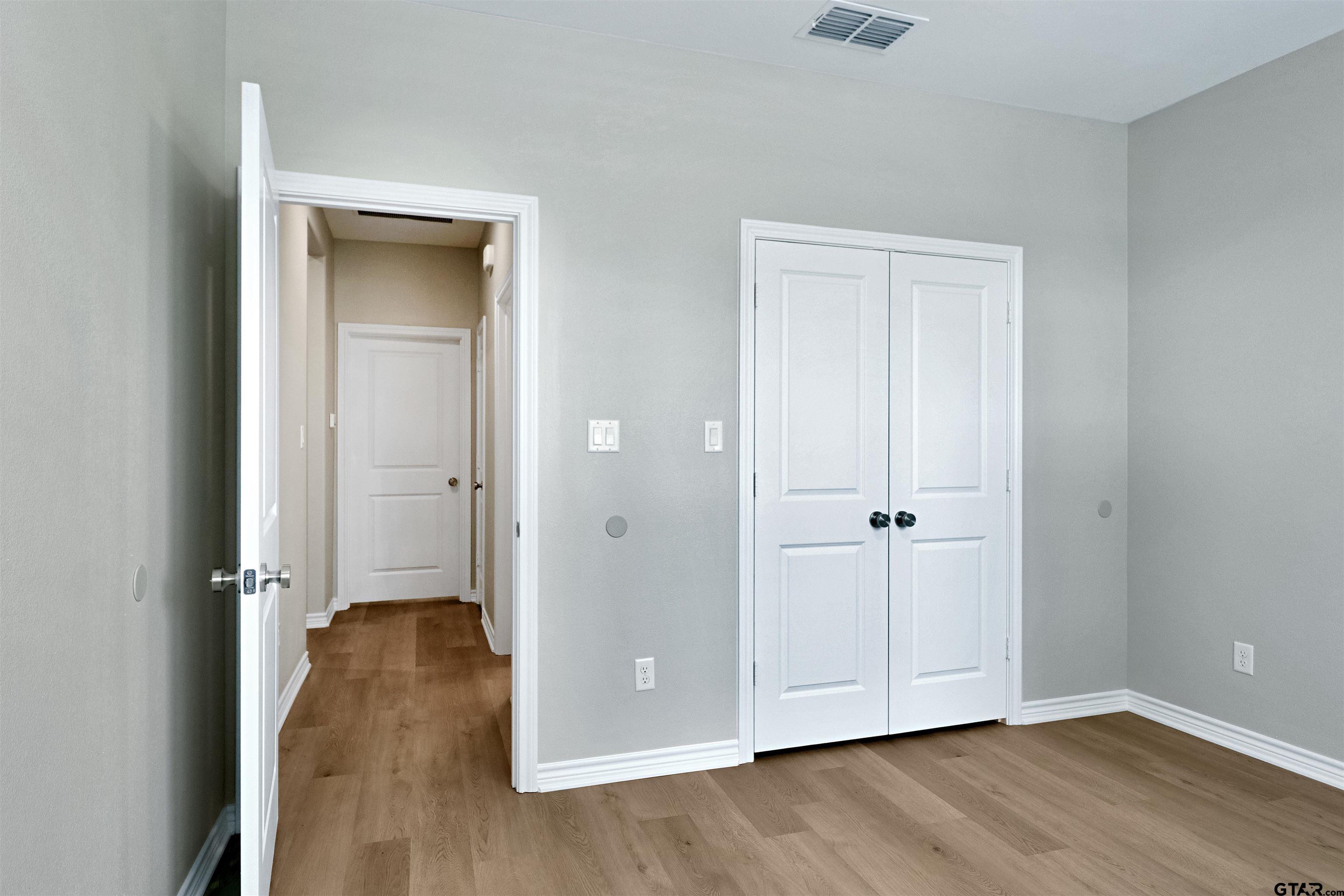 3053 Guinn Farms Road Tyler, TX 75707 - Photo 25 of 32 a view of a hallway with wooden floor