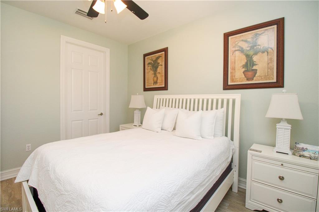 9159 Delano Street, Unit 9905 Naples, FL 34113 - Photo 19 of 44 Bedroom featuring dark hardwood / wood-style floors and ceiling fan