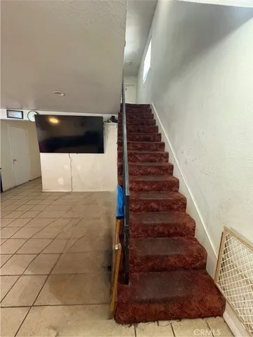 a hallway with a dining table and chairs