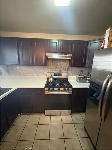 a kitchen with refrigerator and cabinets