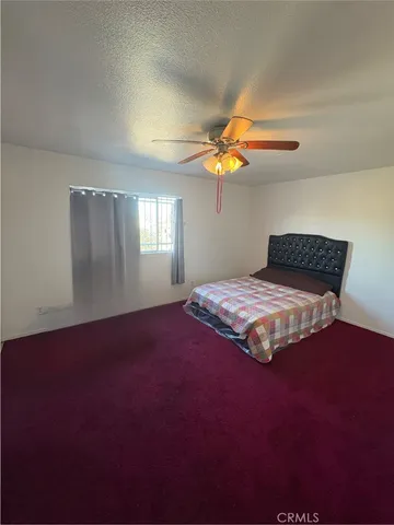 a bedroom with a bed and a mirror