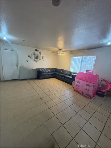 a view of a hallway to a livingroom with furniture