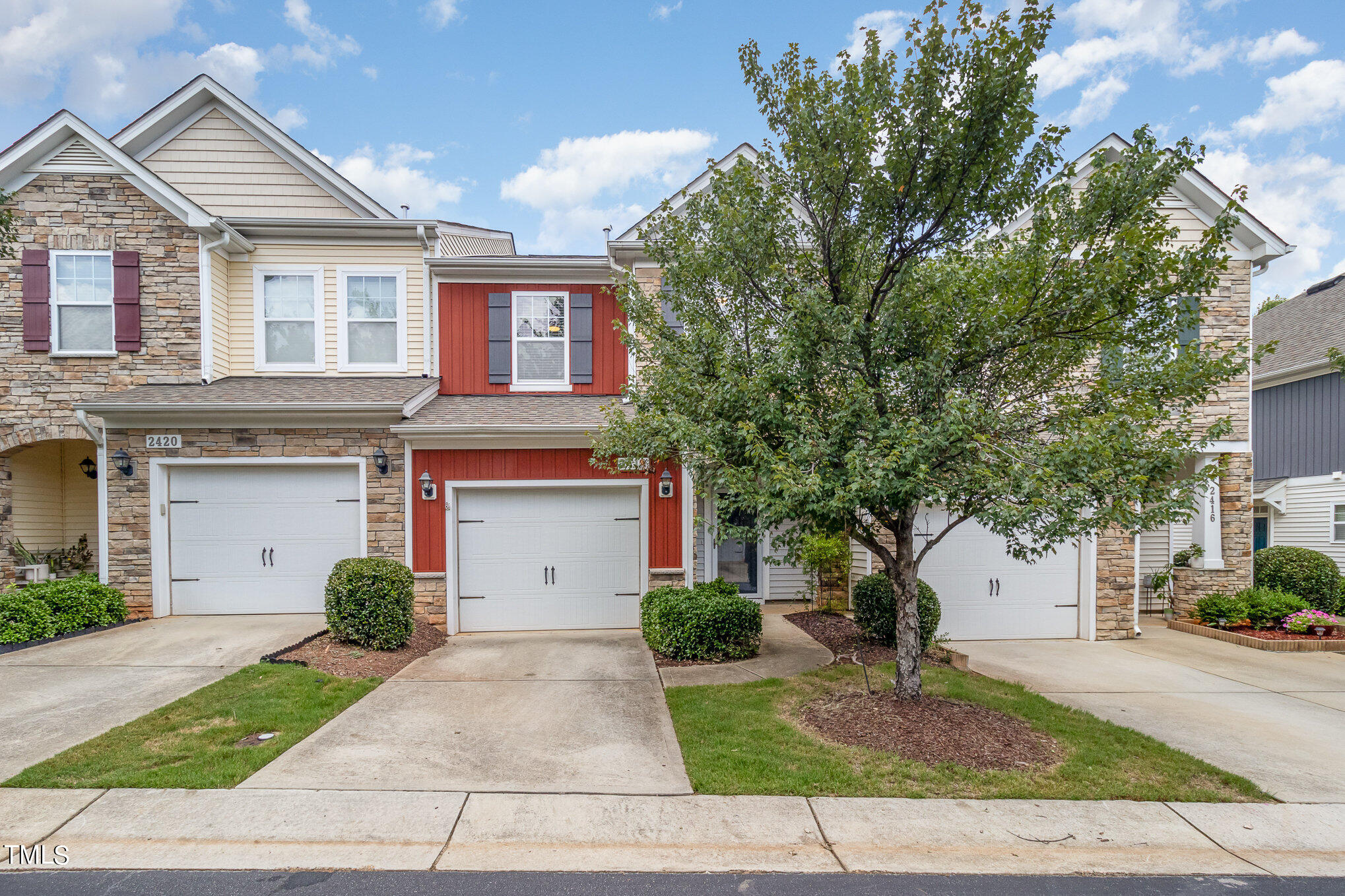 2418 Memory Ridge Drive Raleigh, NC 27606 - Photo 1 of 27 a front view of a house with a yard and garage