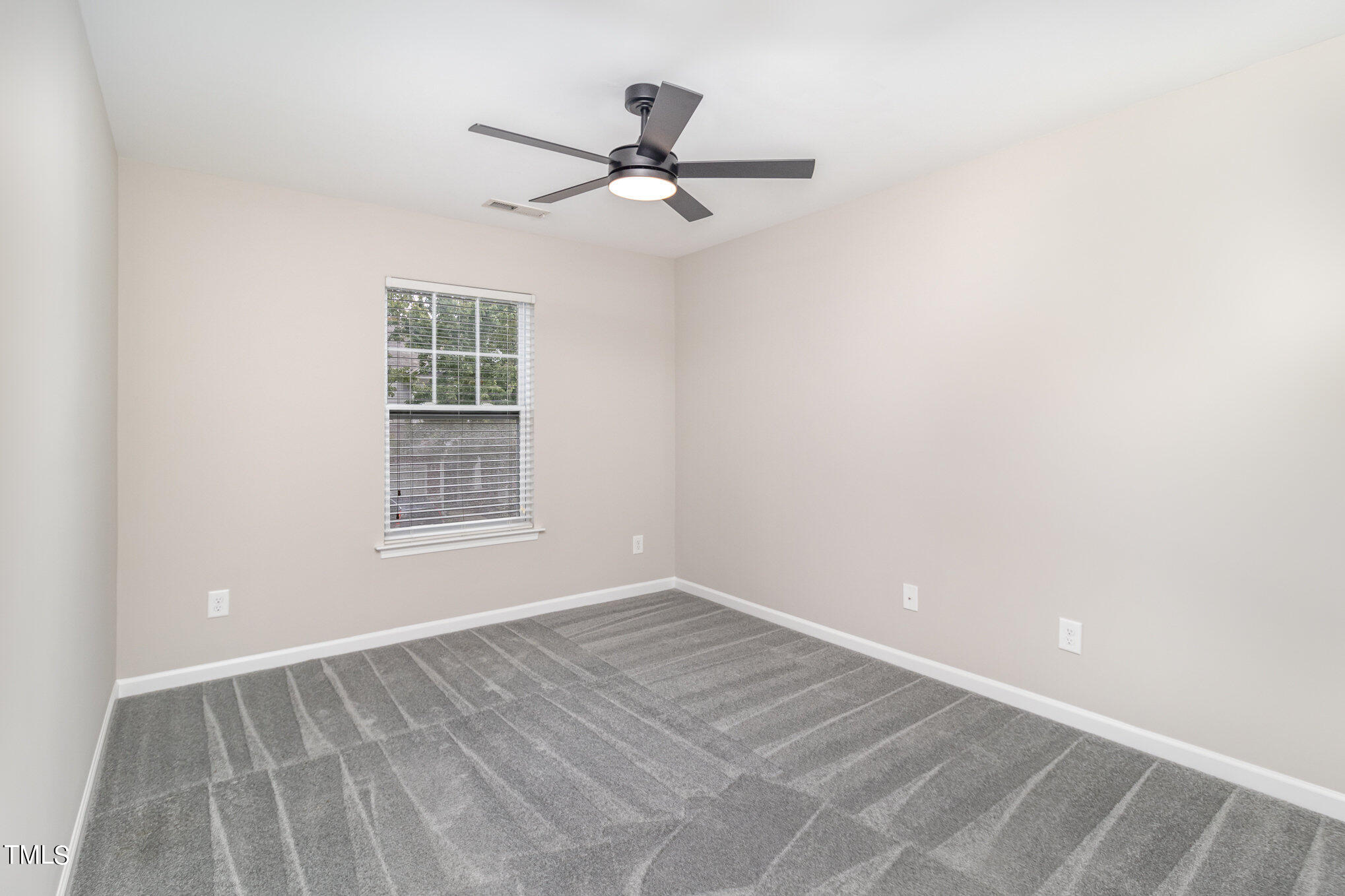 2418 Memory Ridge Drive Raleigh, NC 27606 - Photo 14 of 27 an empty room with ceiling fan and window