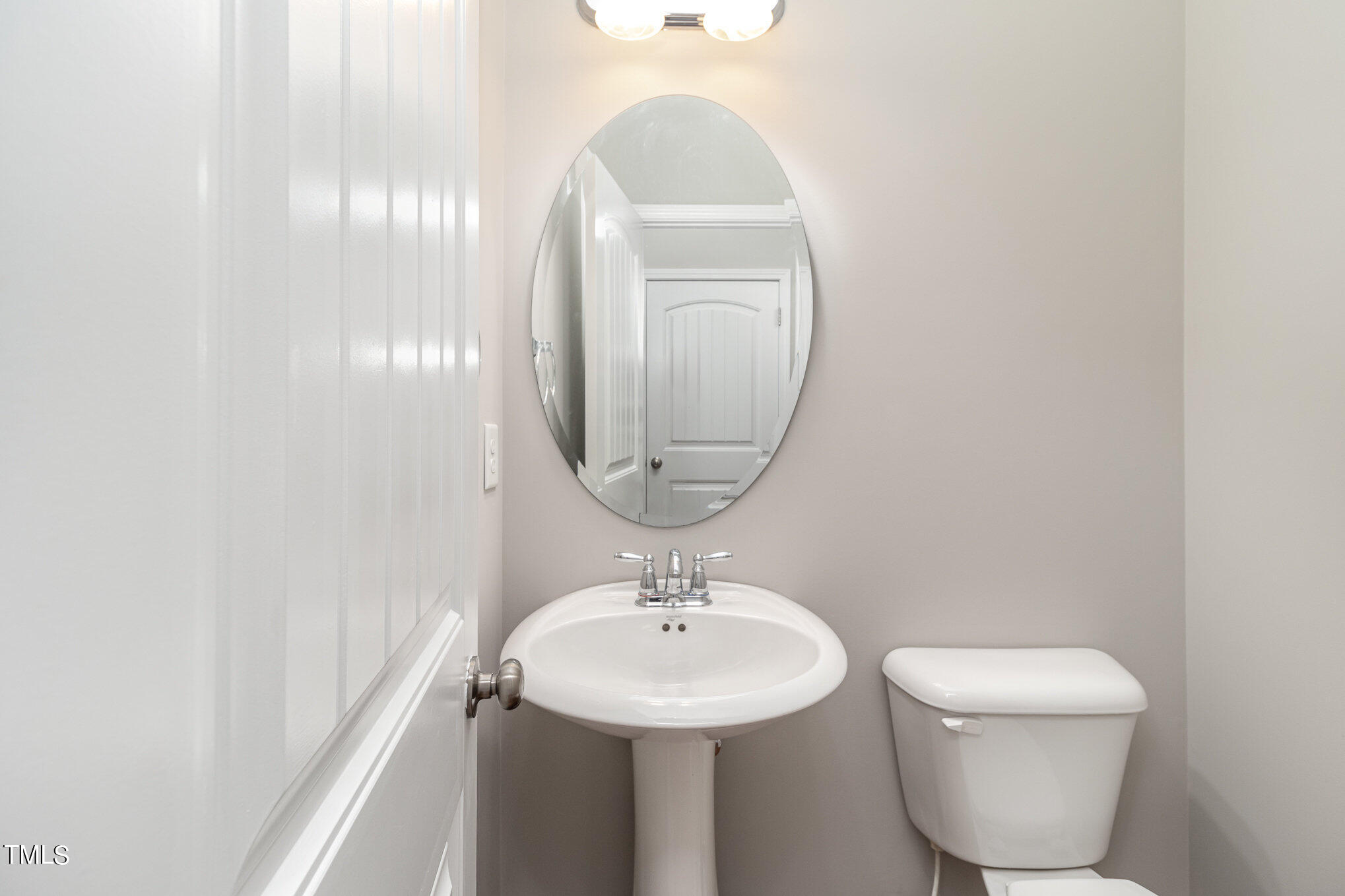 2418 Memory Ridge Drive Raleigh, NC 27606 - Photo 5 of 27 a bathroom with a toilet a sink and mirror