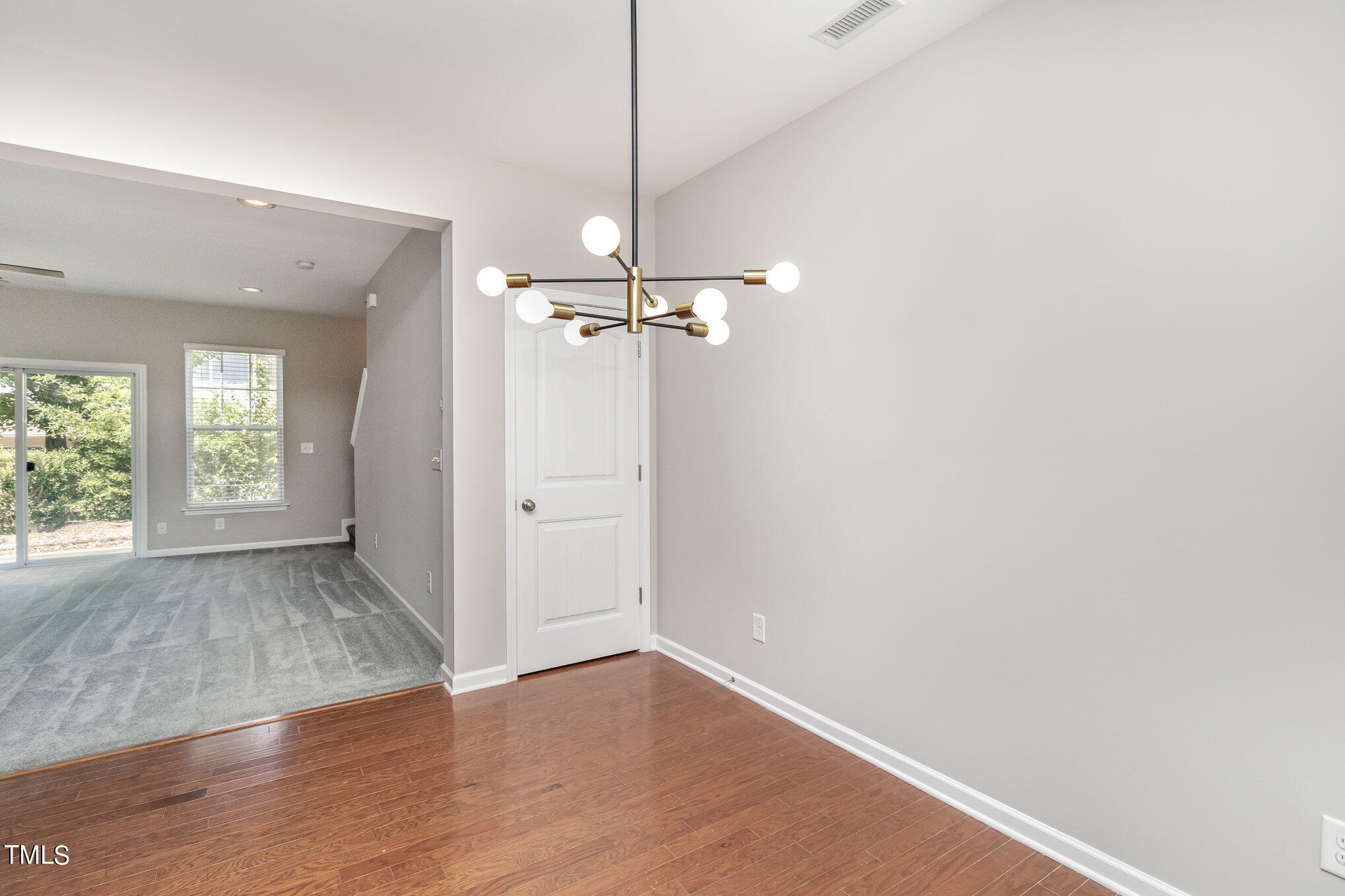 2418 Memory Ridge Drive Raleigh, NC 27606 - Photo 6 of 27 wooden floor in an empty room with a window