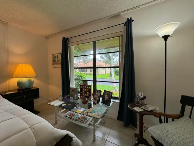 a living room with furniture and a lamp