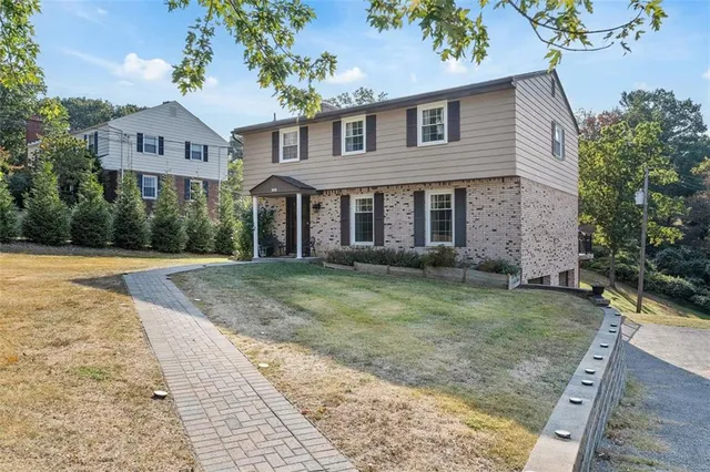 a front view of a house with garden