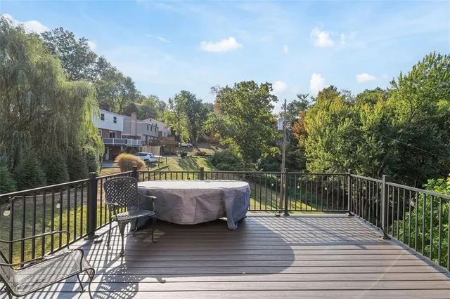 a view of a roof deck with chair and wooden floor