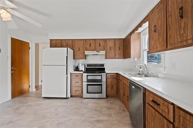 a kitchen with a sink and a refrigerator
