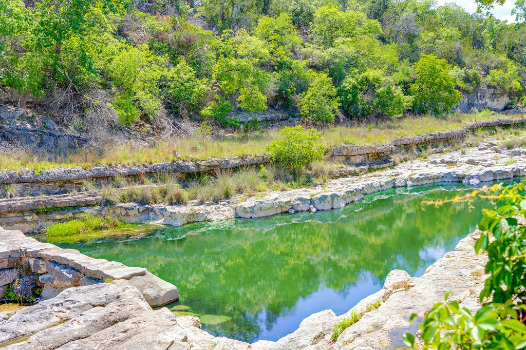 37 South Ranch Road 783 Harper, TX 78631 - Photo 19 of 19 a view of a lake with lawn chairs and large trees