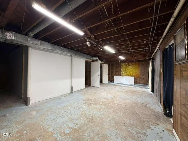 a view of empty room with wooden walls