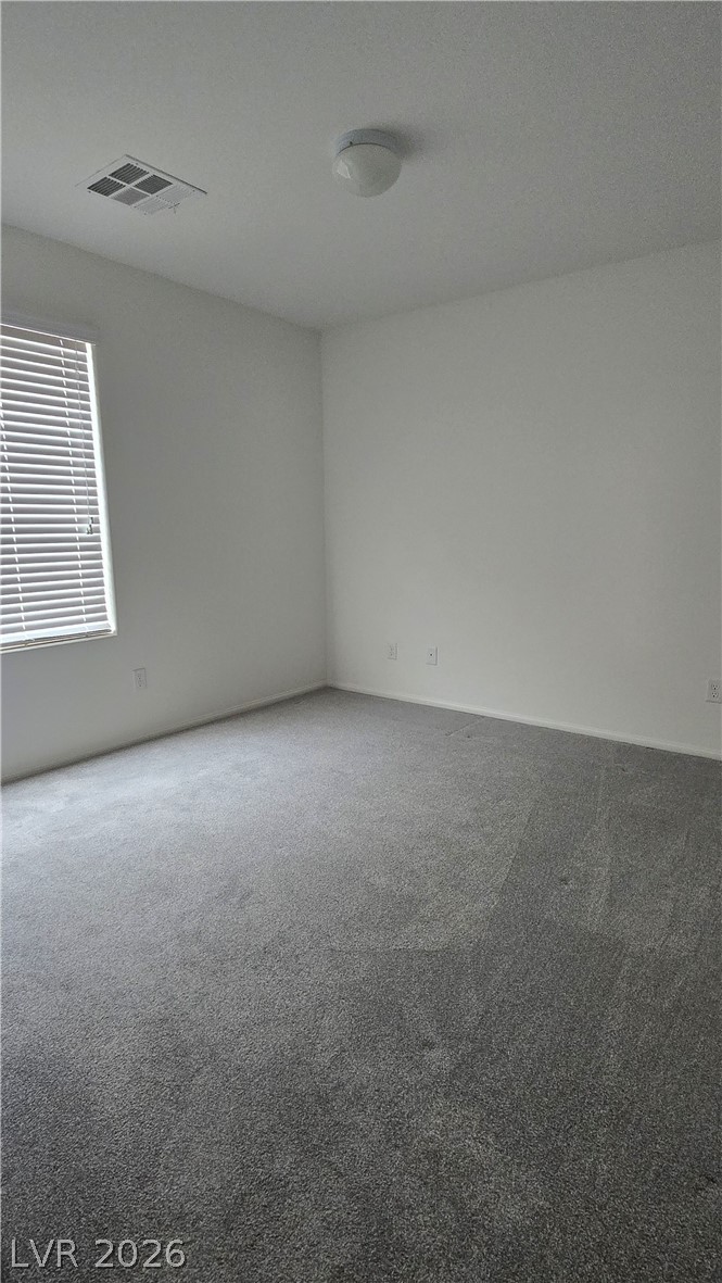 891 Earth Luster Road Las Vegas, NV 89178 - Photo 15 of 20 Plush wall-to-wall carpeting and clean neutral walls define this versatile bedroom space.