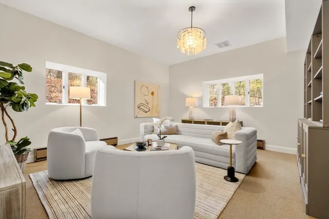 a living room with furniture and a chandelier