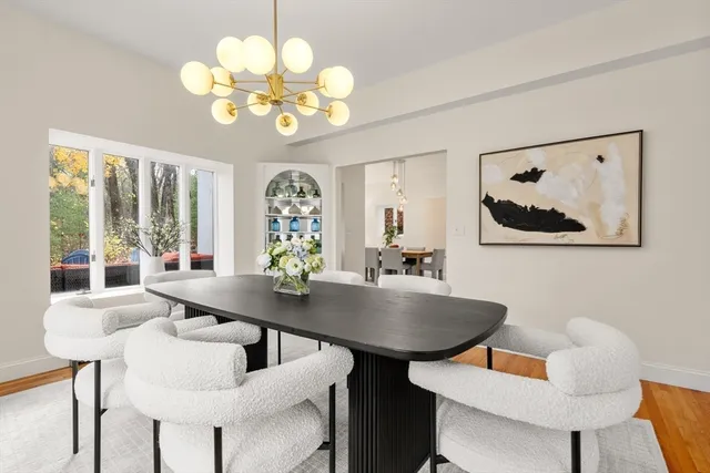a view of a dining room with furniture and chandelier