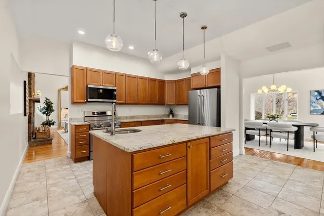 a kitchen with stainless steel appliances granite countertop a stove oven and a refrigerator