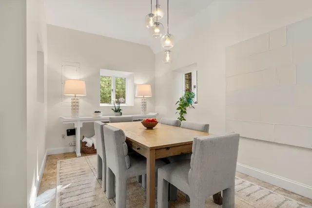 a view of a dining room with furniture and a chandelier