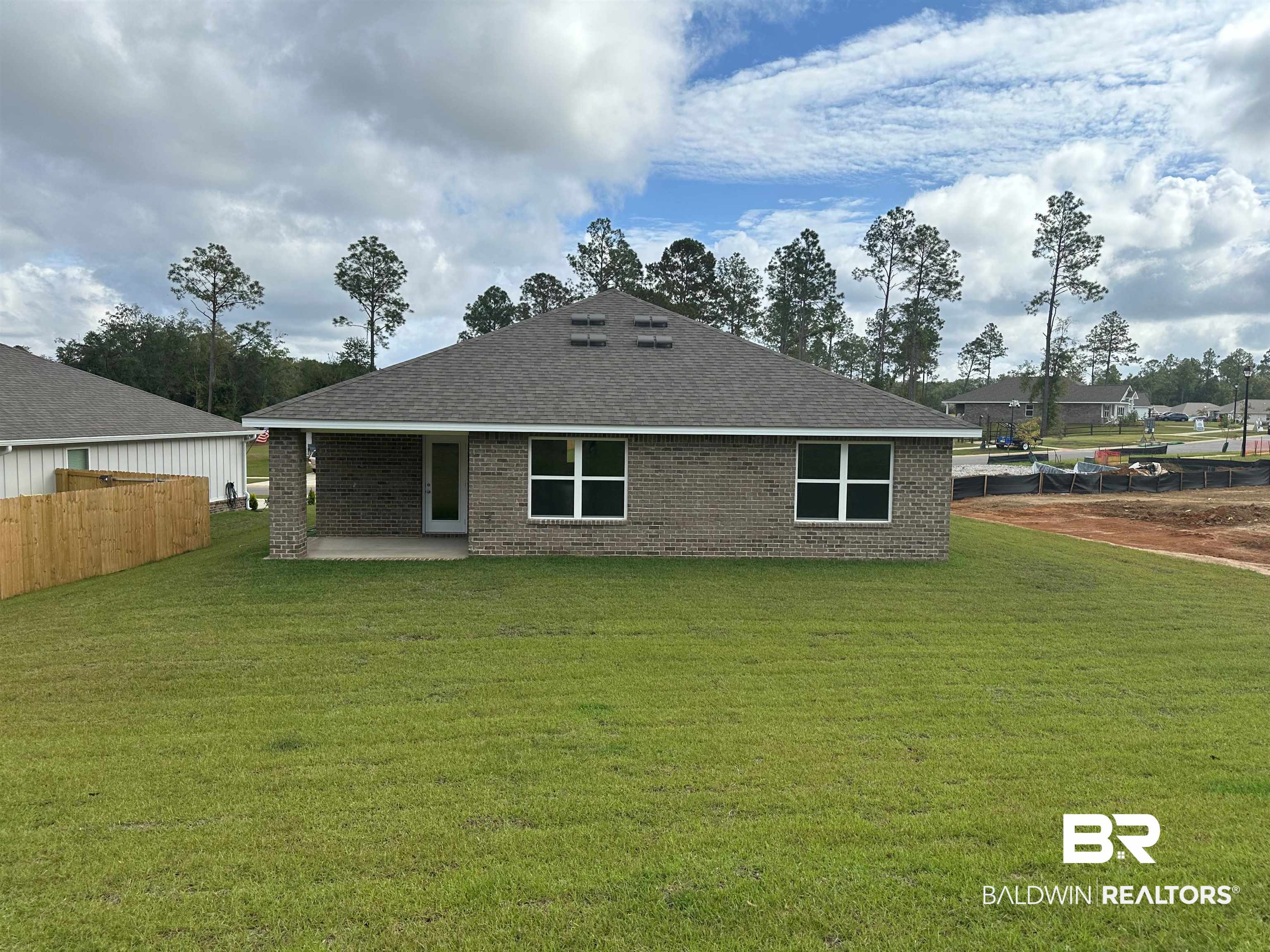 16388 Laurelbrooke Loop, Unit 39 CALI Fairhope, AL 36532 - Photo 5 of 30 Rear view of property featuring a patio and a lawn