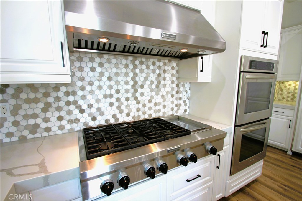 5016 Corral Court Rancho Cucamonga, CA 91737 - Photo 11 of 70 a kitchen with granite countertop a stove and a shower
