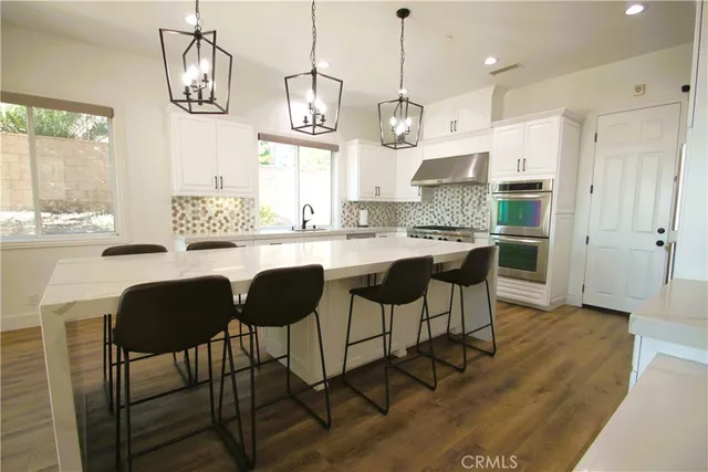 a dining room with a window and chandelier