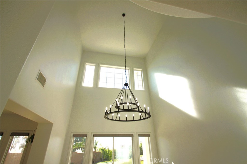5016 Corral Court Rancho Cucamonga, CA 91737 - Photo 23 of 70 a dining room with a window and chandelier