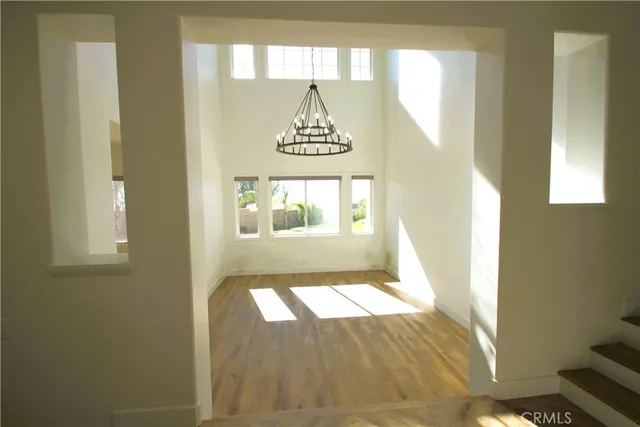 a view of an empty room with a window and fireplace