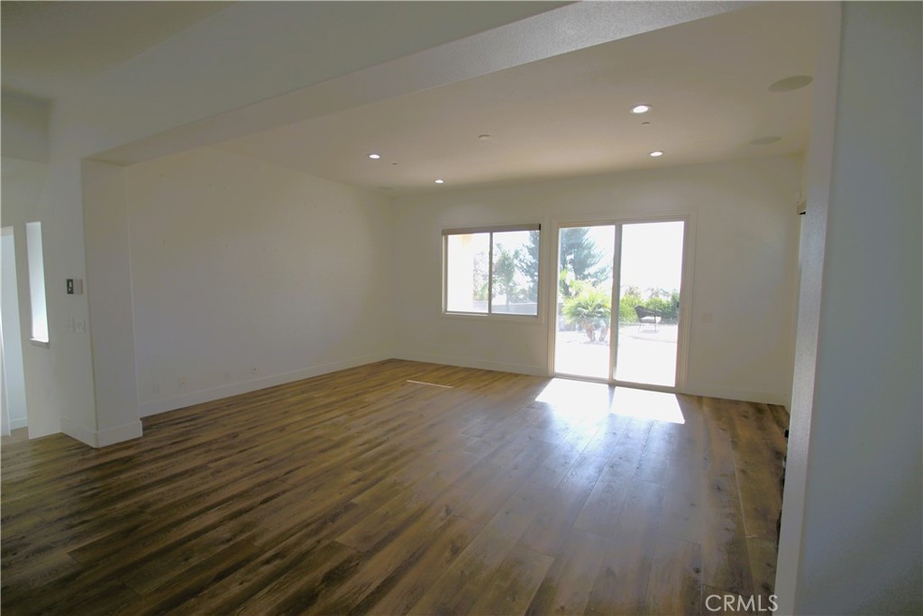 5016 Corral Court Rancho Cucamonga, CA 91737 - Photo 27 of 70 an empty room with wooden floor and windows