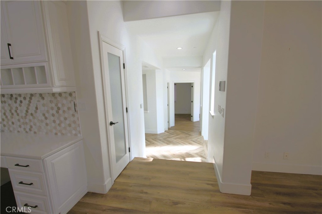 5016 Corral Court Rancho Cucamonga, CA 91737 - Photo 28 of 70 a view of a hallway with wooden floor and a bathroom