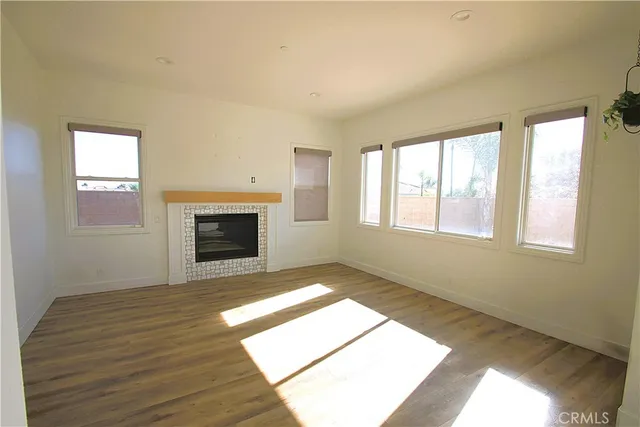 an empty room with windows and closet