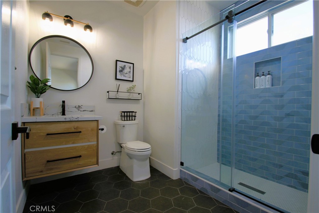 5016 Corral Court Rancho Cucamonga, CA 91737 - Photo 32 of 70 a bathroom with a toilet a sink and a mirror