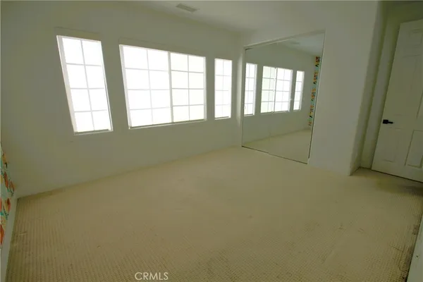 a view of a big room with windows and closet
