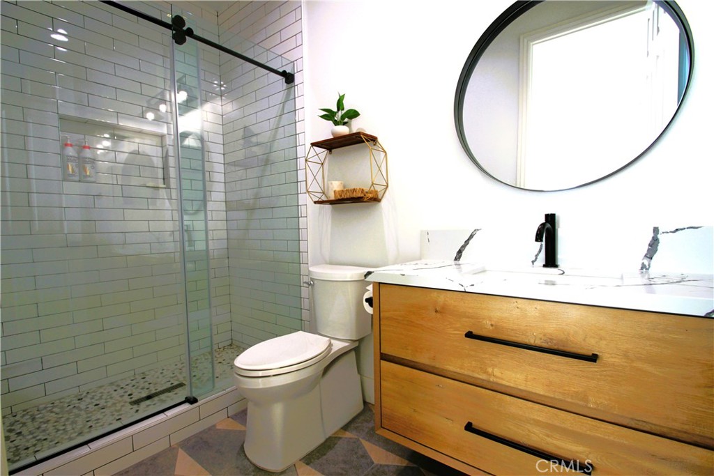 5016 Corral Court Rancho Cucamonga, CA 91737 - Photo 36 of 70 a bathroom with a sink a toilet and a mirror