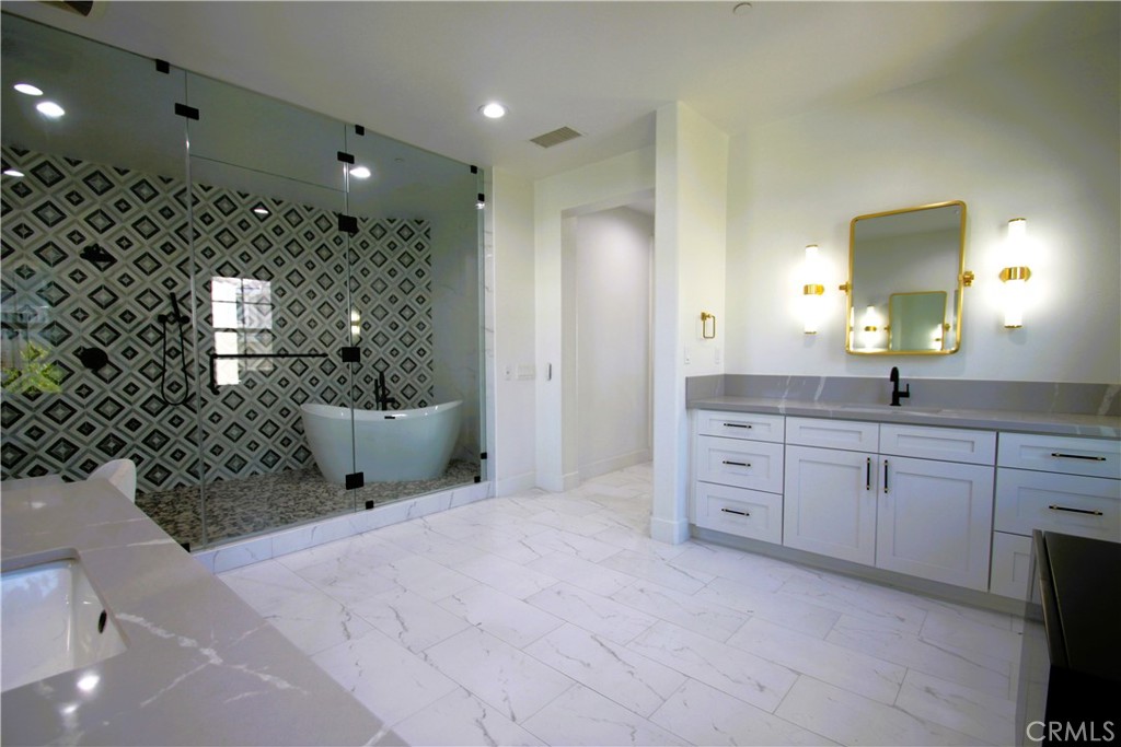 5016 Corral Court Rancho Cucamonga, CA 91737 - Photo 52 of 70 a spacious bathroom with a double vanity sink a mirror and shower