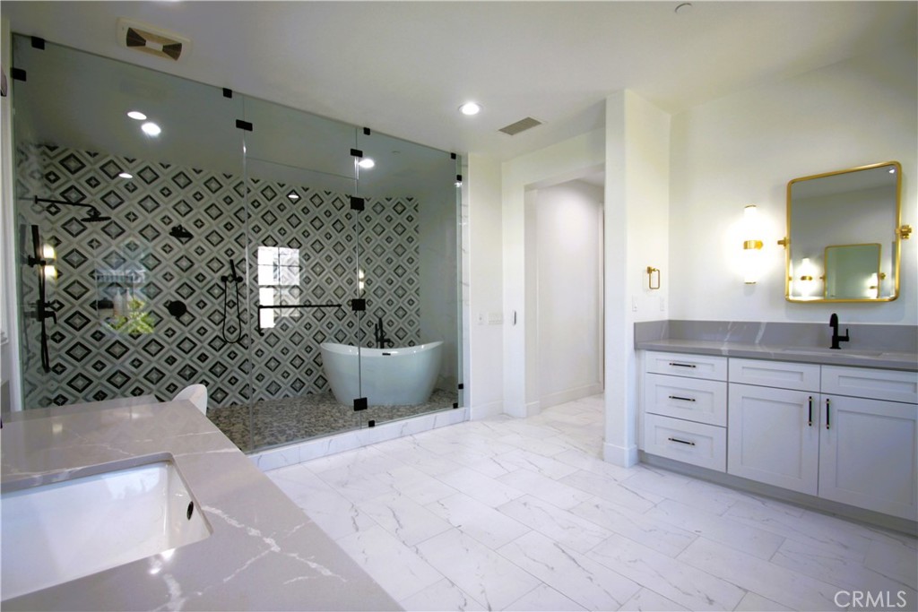 5016 Corral Court Rancho Cucamonga, CA 91737 - Photo 54 of 70 a spacious bathroom with a double vanity sink a large mirror and shower