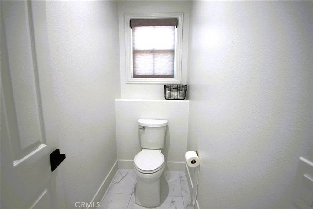 5016 Corral Court Rancho Cucamonga, CA 91737 - Photo 57 of 70 a white toilet sitting in a bathroom next to a window