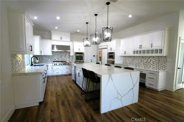 a kitchen with cabinets appliances and a counter top space