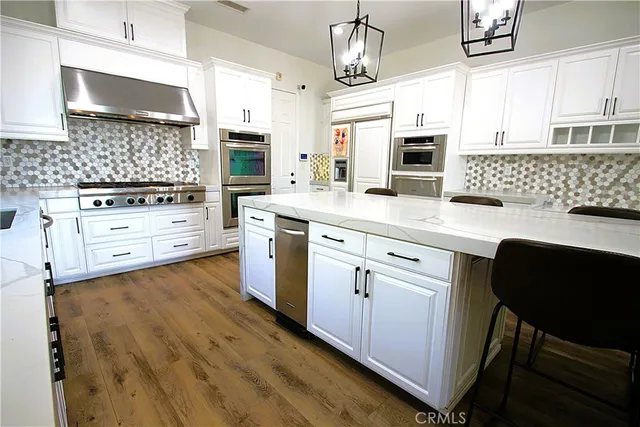 a kitchen with granite countertop a stove and a shower