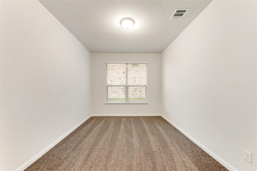 1419 Fox Hollow Road Krum, TX 76249 - Photo 14 of 29 Carpeted spare room featuring a textured ceiling and baseboards