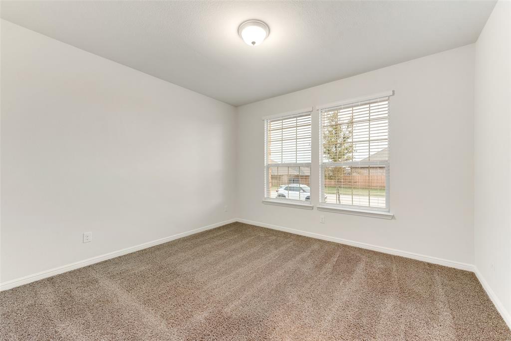 1419 Fox Hollow Road Krum, TX 76249 - Photo 16 of 29 Carpeted spare room featuring baseboards