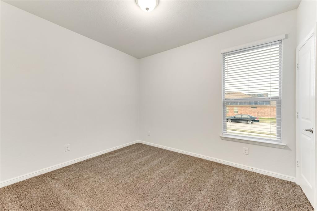 1419 Fox Hollow Road Krum, TX 76249 - Photo 17 of 29 Empty room featuring carpet floors and baseboards