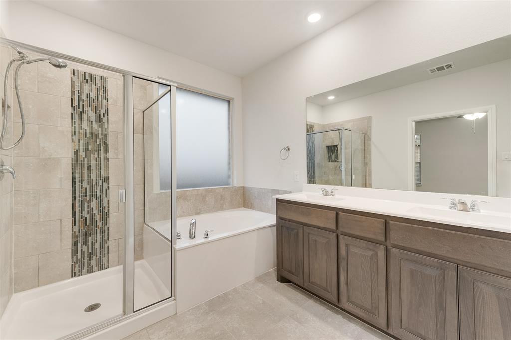 1419 Fox Hollow Road Krum, TX 76249 - Photo 23 of 29 Full bath featuring double vanity, a bath, a shower stall, and light tile patterned flooring