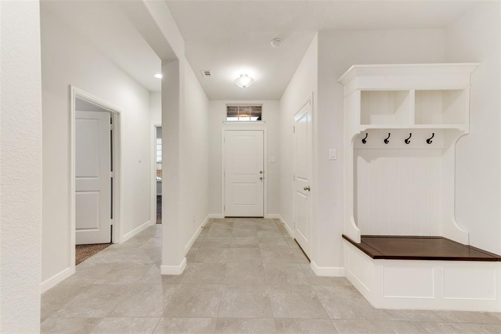 1419 Fox Hollow Road Krum, TX 76249 - Photo 5 of 29 Mudroom featuring light tile patterned floors and baseboards
