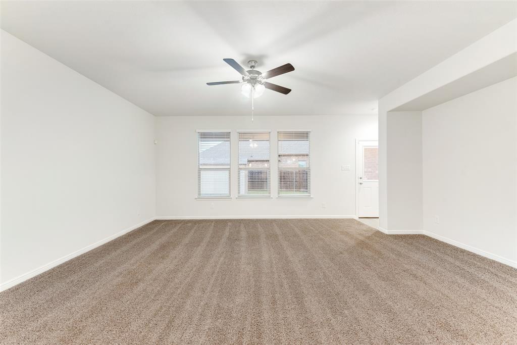 1419 Fox Hollow Road Krum, TX 76249 - Photo 9 of 29 Carpeted empty room with baseboards and ceiling fan