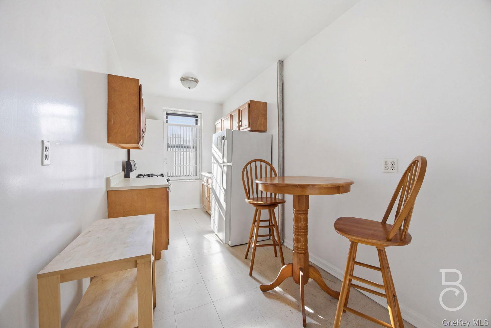 37-16 83rd Street, Unit 3F Queens, NY 11372 - Photo 8 of 11 a view of a kitchen with kitchen island and a sink
