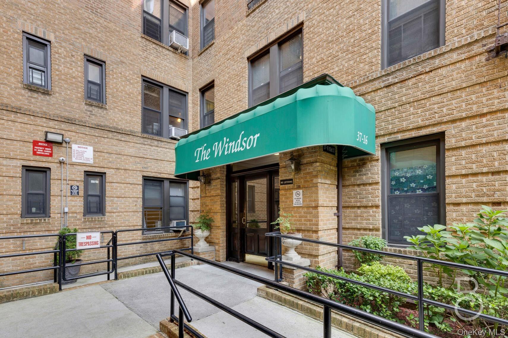 37-16 83rd Street, Unit 3F Queens, NY 11372 - Photo 10 of 11 a front view of a building with glass windows and stairs