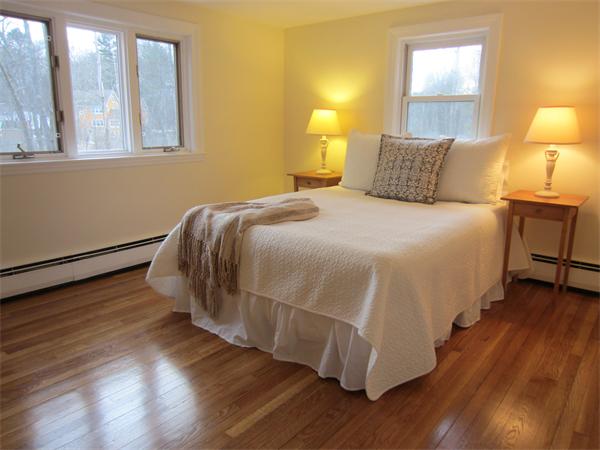 221 Lincoln Road Lincoln, MA 01773 - Photo 11 of 17 a bedroom with a bed and wooden floor