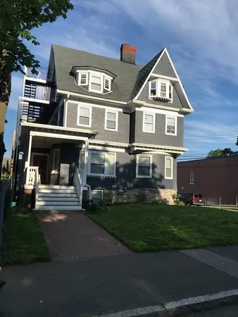 a front view of a house with a yard